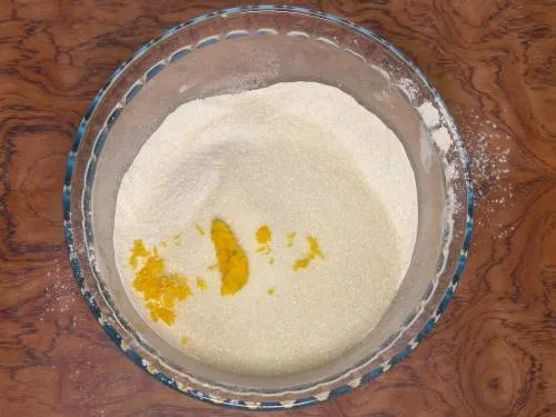 adding sugar and orange zest 