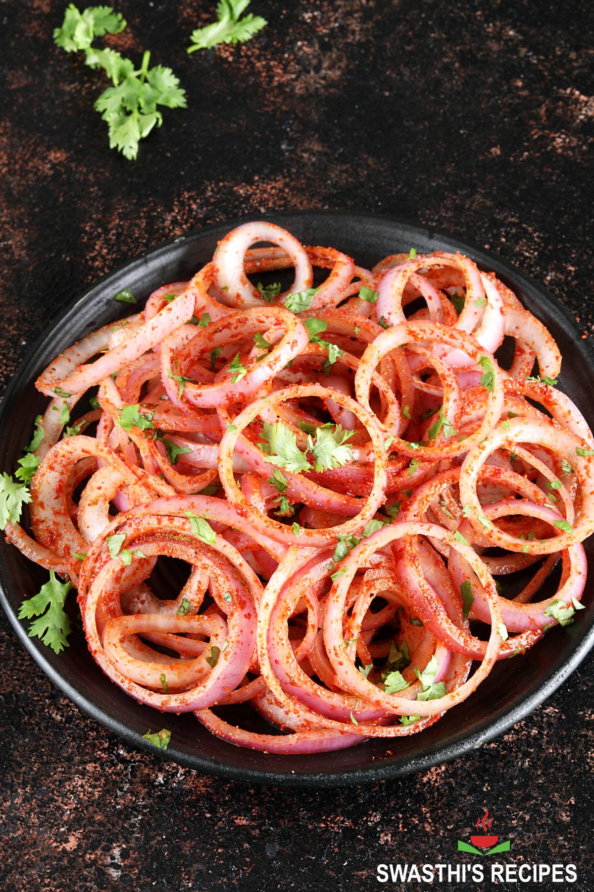 Onion salad made with raw onion rings, spices and lemon juice